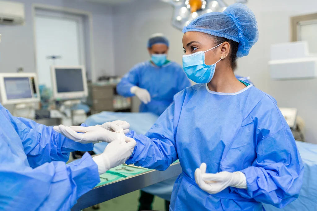 Blue Nurse Helping Surgeon